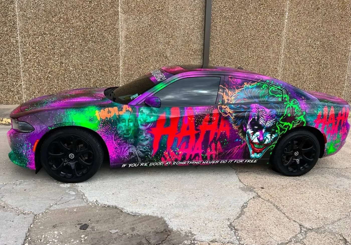 A colorful, graffiti-style painted car with the word 'HATE' prominently displayed.